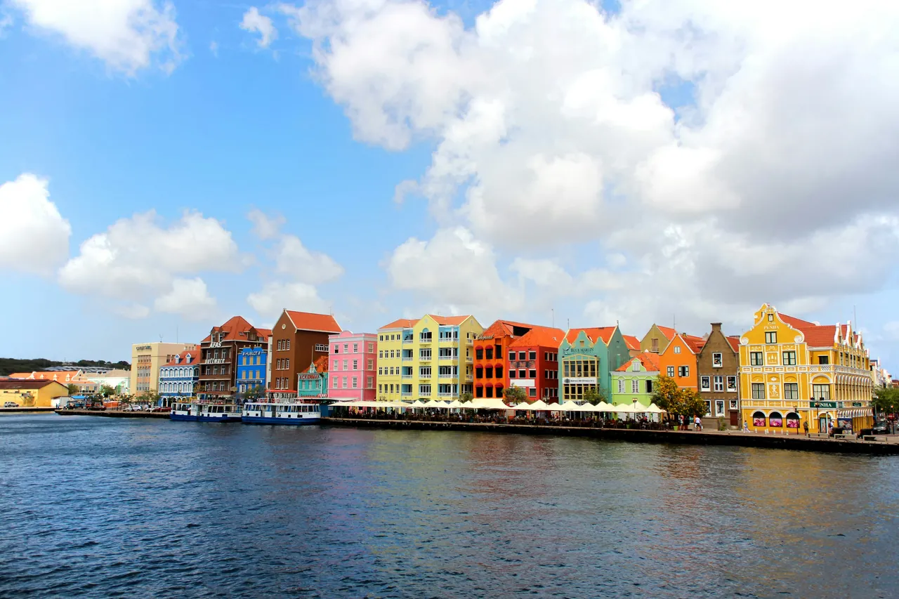 The pastel waterfront houses of Willemstad, Curaçao, seen across the harbour