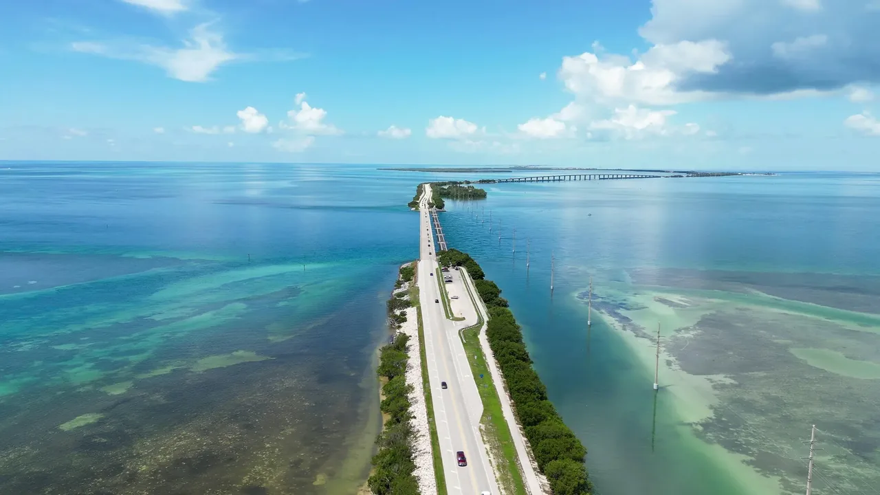 The Overseas Highway running in a straight line across shallow turquoise water between the Florida Keys