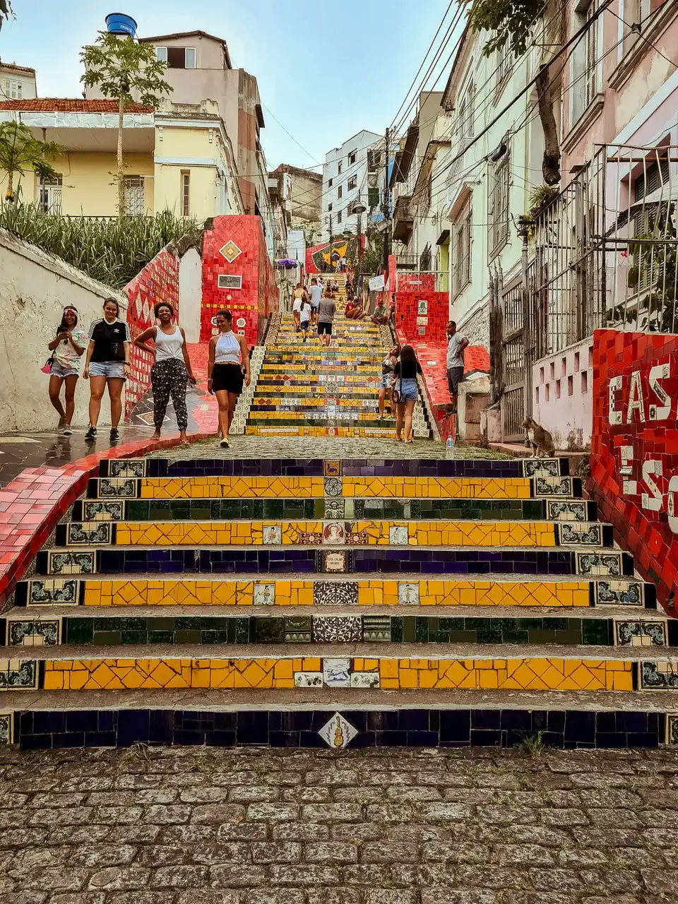 The tiled Selarón Steps in Rio de Janeiro, with people sitting on the mosaic stairs